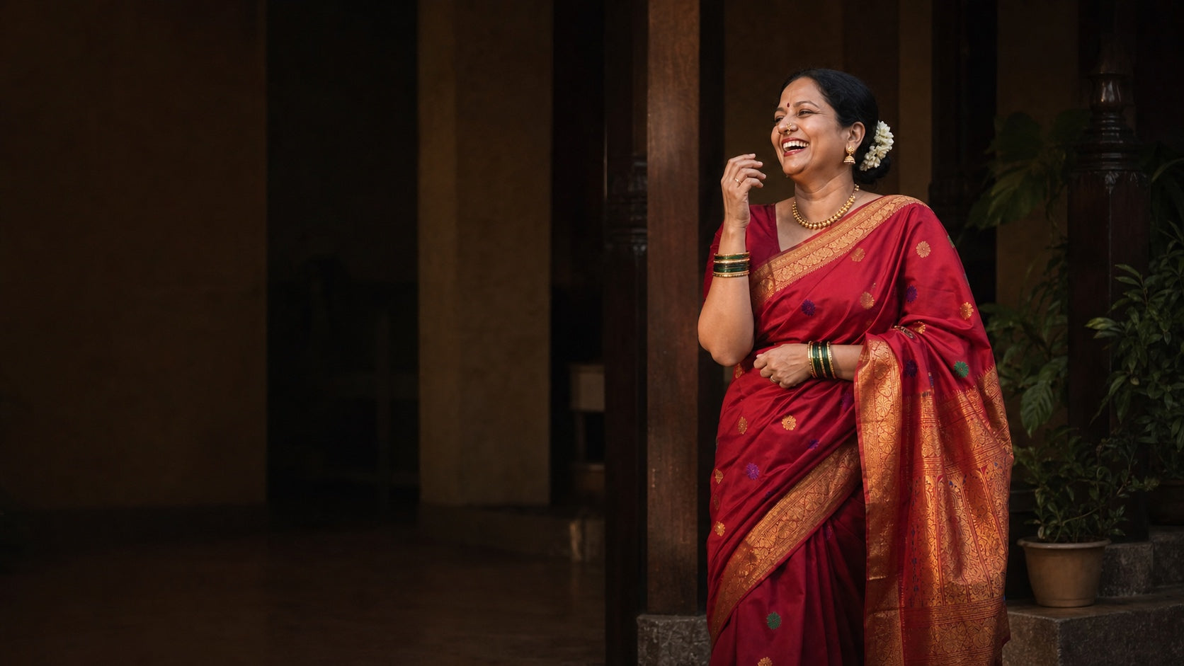 Joyful woman wearing a red Paithani saree